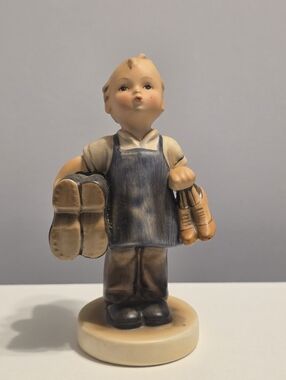 Goebel Hummel piece titled "Boots" (also known by its German name, Stiefel).
